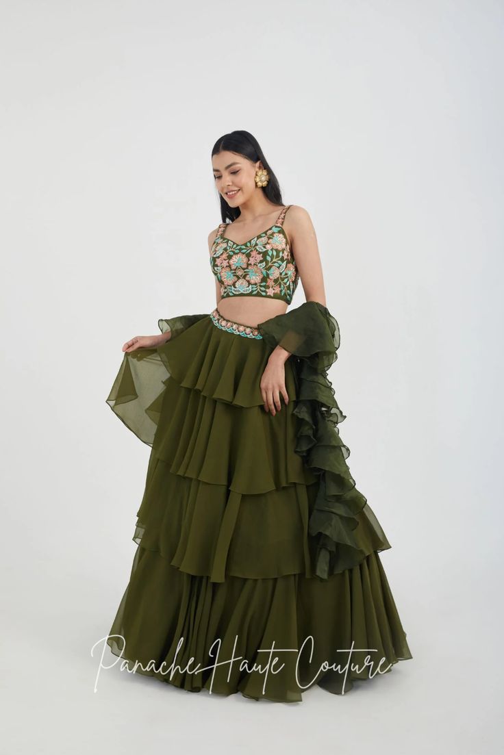 Mehendi Color Tiered Skirt with Crop Top – Panache Haute Couture Green Sharara With Ruffles And Traditional Drape, Green Ruffled Sharara With Traditional Drape, Elegant Green Sharara With Ruffles, Green Georgette Set With Ruffles, Elegant Green Ruffled Sharara, Tiered Ruffle Georgette Lehenga, Floor-length Ruffled Georgette Choli, Festive Georgette Dress With Ruffles, Wedding Sharara With Ruffles And Tiered Skirt