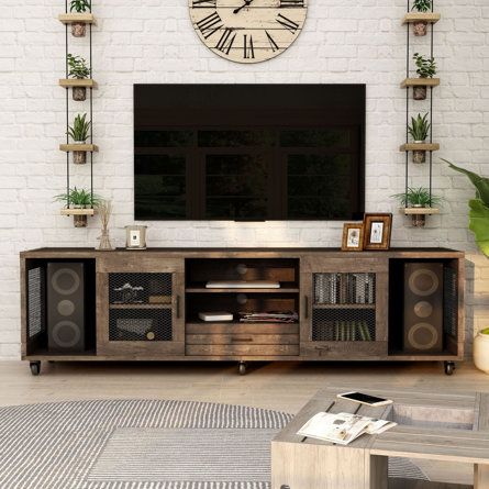 a living room with a large clock mounted to the wall above it's entertainment center