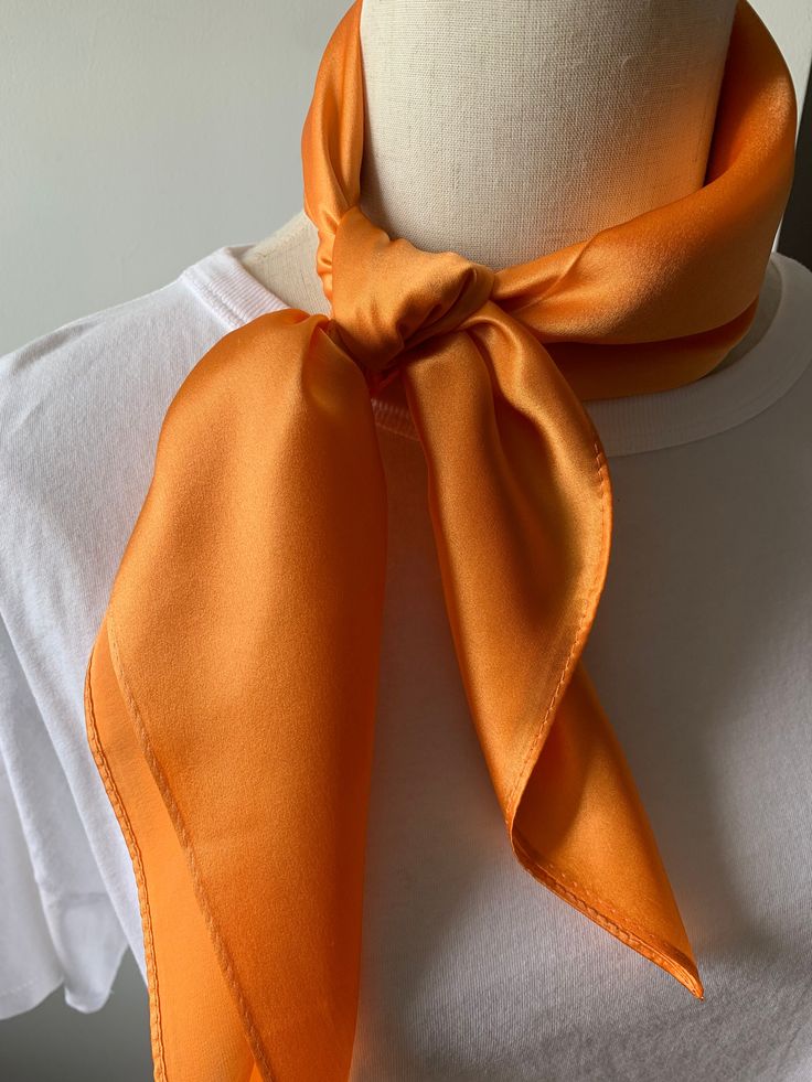 Luxurious solid color pure mulberry silk square scarf, Orange, Size: 65 cm x 65 cm / 26 in x 26 in. Soft, smooth, and lustrous silk charmeuse fabric, breathable and skin-friendly feels very soft and comfortable to wear. Can style in many ways: you can wear this scarf as a soft neck scarf, as a hair tie, as a head band scarf, as a wrist scarf, as a purse accessory scarf. Or style it in any way you want with your own sense of creativity! Suitable for all seasons and is a great gift idea for specia Silk Scarves Perfect For Gifts, Satin Silk Scarf Gift, Solid Silk Scarf Gift, Elegant Orange Silk Scarf For Gift, Elegant Orange Silk Scarf As Gift, Elegant Orange Silk Scarf, Silk Orange Scarves As A Gift, Orange Silk Scarves As A Gift, Silk Orange Scarves As Gift