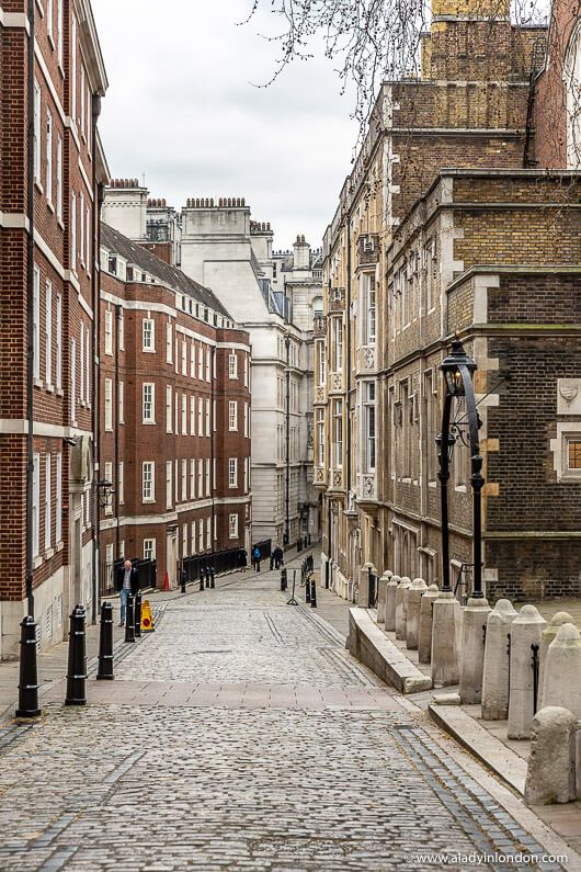 an old cobblestone street lined with tall brick buildings