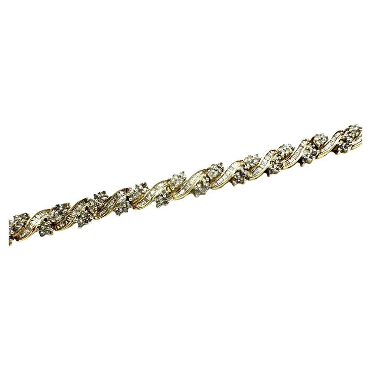 This 10-carat diamond baguette link bracelet is the perfect way to add a brilliant sparkle to any look. Crafted with intricate detail, this cluster diamond link bracelet will make anyone sparkle. 10-karat yellow gold diamond encrusted link bracelet. Diamonds are alternating in rows of round clusters separated by baguette channel strips. The total weight of diamonds is 2.50 carats. The quality of the diamonds is SI3 clarity and H color. Length is 7 inches. Channel Strips, Diamond Baguette, Baguette Diamond, Diamond Cluster, Link Bracelets, Baguette, Diamond Bracelet, Gold Diamond, Gold Bracelet