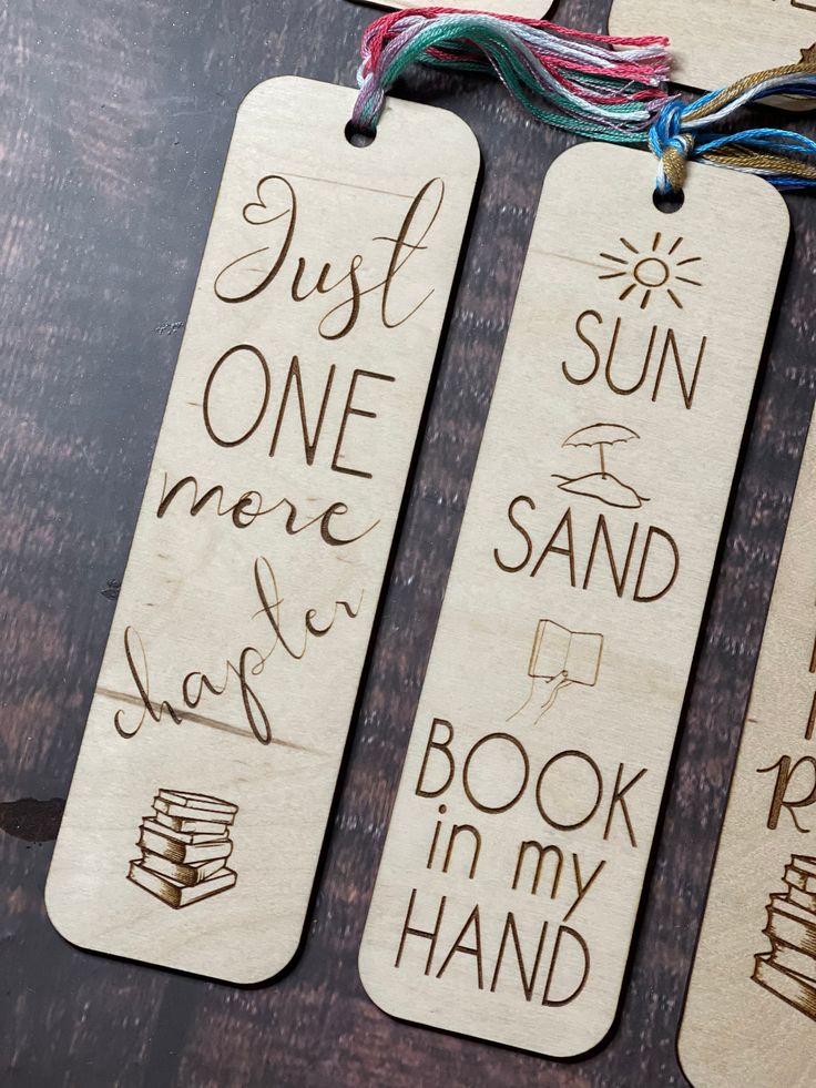 three wooden bookmarks with writing on them