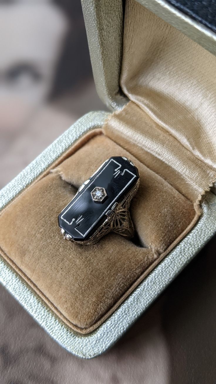 Incredible 1920s Art Deco antique ring! Made of 14K white gold with a gorgeous rectangular onyx stone with pretty diamond set in the center. Stone has a delicate silver art deco design and is set in a beautiful and intricate filagree setting. In wonderful condition! 22mm X 10mm 14K gold weight 3 grams Vintage Diamond Enamel Ring, Elegant Silver Enamel Ring With Black Details, Victorian Rectangular Polished Jewelry, Elegant Sterling Silver Signet Ring With Rectangular Stone, Elegant Silver Enamel Ring, Elegant Black Enamel 14k Gold Ring, Elegant Black Enamel Ring In 14k Gold, Elegant 14k Gold Enamel Ring, Elegant 14k Gold Black Enamel Ring