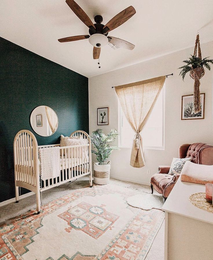 a baby's room with a crib, chair and rug in the corner