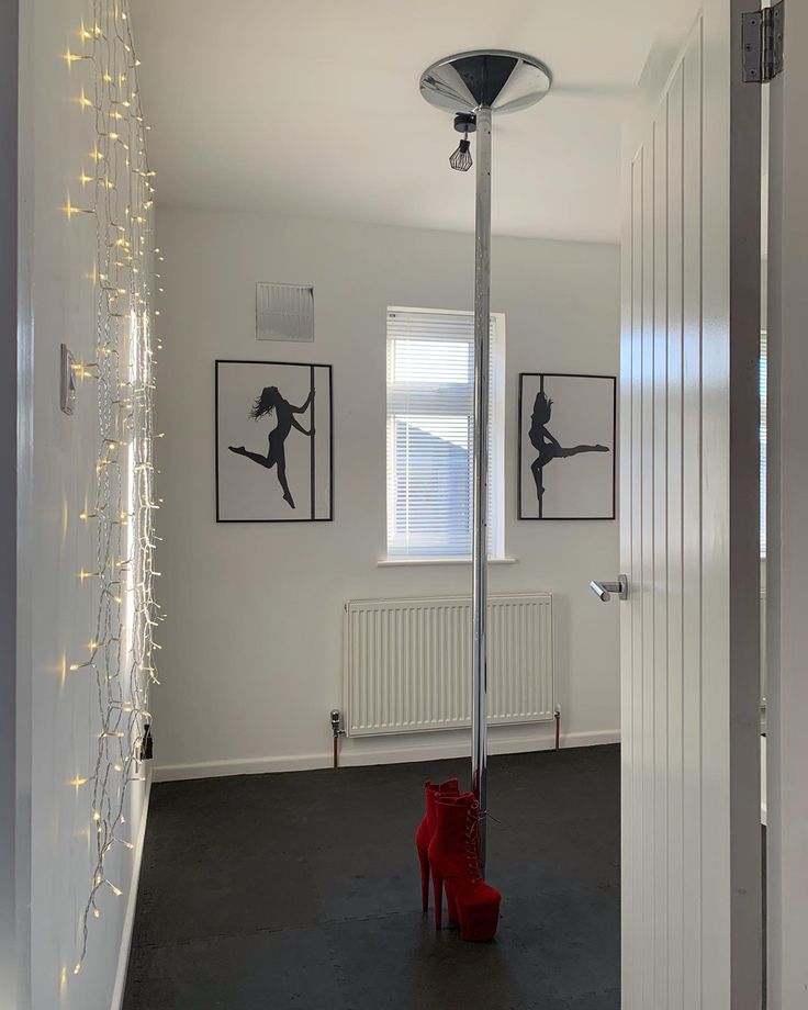 a red boot is standing in the middle of a room with white walls and lights