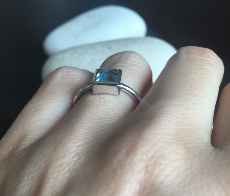 A Teeny square-shaped genuine Swiss Blue Topaz handcrafted in sterling silver, makes a great birthstone ring for those December Birthday gals or a great stackable ring or pinky/thumb/midi ring as it is small stone! Wrapped in a box ready for gift giving.(r-new-1) Blue Topaz measures 6mm *LIKE* us on Facebook http://www.facebook.com/Belesas to get 10%off coupon code, *FOLLOW* us on Twitter https://twitter.com/#!/Belesas to get more exclusive coupon codes *All item are ready to ship! Free shipping Gift Blue Topaz Ring With Rectangular Shape, Gift Blue Topaz Rectangular Ring, Sterling Silver Square Cut Topaz Ring Gift, Rectangular Stone Topaz Ring In Sterling Silver For Gift, Minimalist Blue Topaz Birthstone Ring Gift, Minimalist Blue Topaz Ring For Gift, Minimalist Blue Topaz Rings As Gift, Modern Stackable Topaz Ring For Gifts, Modern Stackable Topaz Ring As Gift