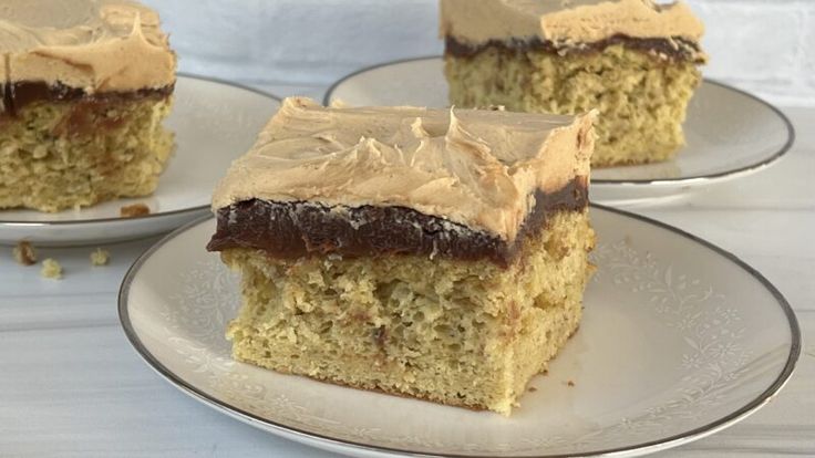 three pieces of cake sitting on top of plates with frosting and chocolate toppings