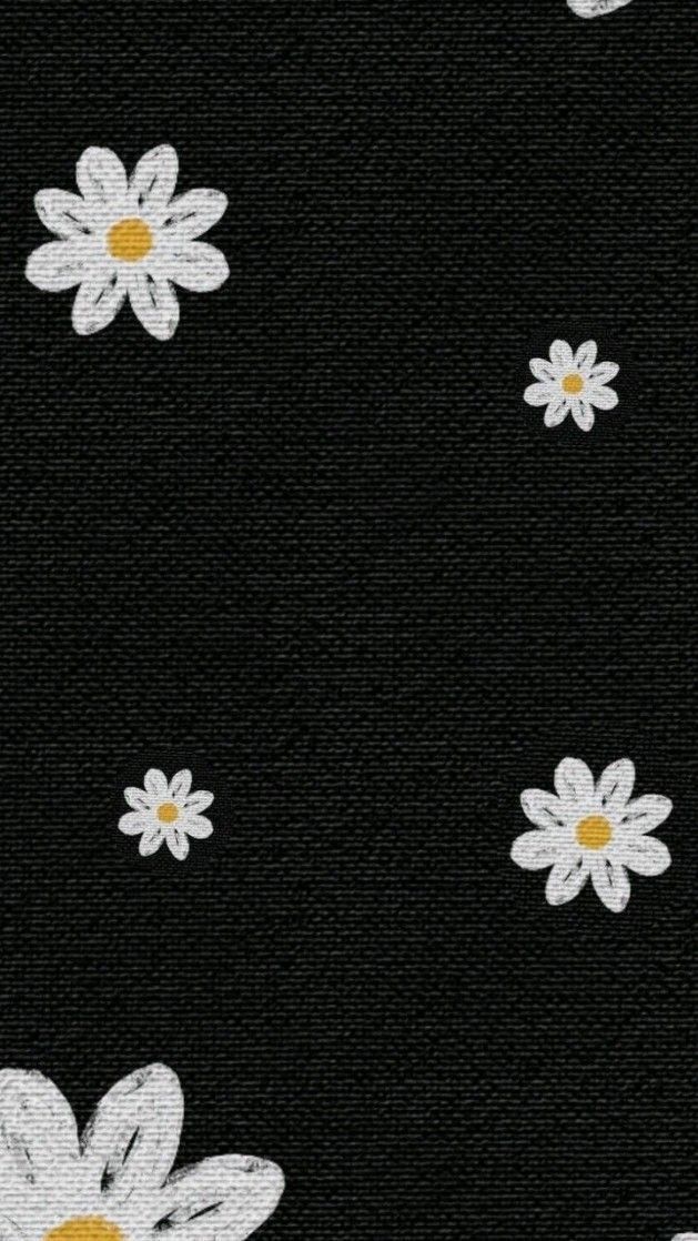 white daisies on black fabric with yellow center in the middle and small white flowers at the bottom