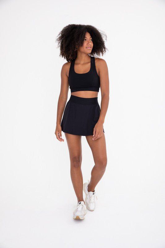 The perfect skirt for on and off the court! It features a seam that swoops all the way around, a thick elastic waistband, and built-in shorts with side pockets. Fabric & fit: 88% nylon 12% spandexMoisture-wickingFour-way stretch Model is wearing size Small. Hiking Leggings, Pole Shorts, Graphic Leggings, Tennis Skort, Bootcut Pants, Clothing Retail, Short Leggings, High Rise Shorts, The Court