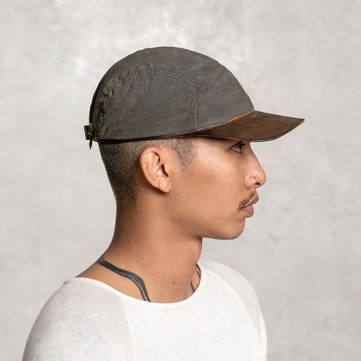 Our five panel Dad Hat (and we mean that in the best way) features a unique hand formed brim and band made out of one continuous piece of veggie tanned leather. The canvas panels are hand painted in a charred olive color way. An adjustable leather tieback provides a comfortable fit. FEATURESVegetable tanned leather brim and bandHand painted canvas panelsWhite brass placardAdjustable leather tiebackOne size fits all 5-panel Leather Hat For Outdoor, Leather 5-panel Hat For Outdoor, Brown Leather 5-panel Hat, Five Panel, Winter Cap, Veg Tan Leather, Hat For Man, New Dads, Olive Color