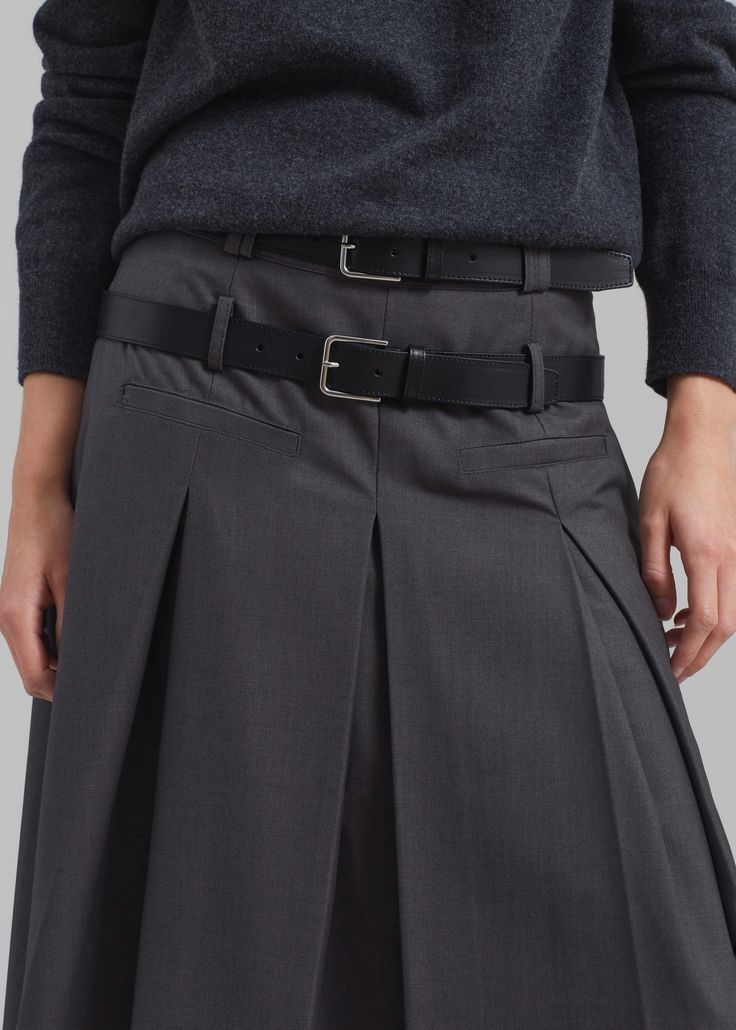 Color: Grey Lightweight woven fabric Relaxed fit Midi length Tennis pleats throughout Front illusion welt pockets Double belt loops Concealed side seam zip closure Partially lined 60% Polyester 25% Rayon 15% Wool Dry Clean By The Frankie Shop. Imported Formal Fitted Skirt With Belt Detail, Modern Skirt With Belt Loops For Work, Fall Workwear Belted Pleated Skirt, Belted Asymmetrical Skirt For Workwear, Workwear Pleated Skirt With Belt Loops, Short Length, Workwear Short Pleated Skirt With Belt Loops, Classic Belted Office Skirt, Classic Belted Skirt For Workwear, Chic Workwear Skirt With Belt Detail