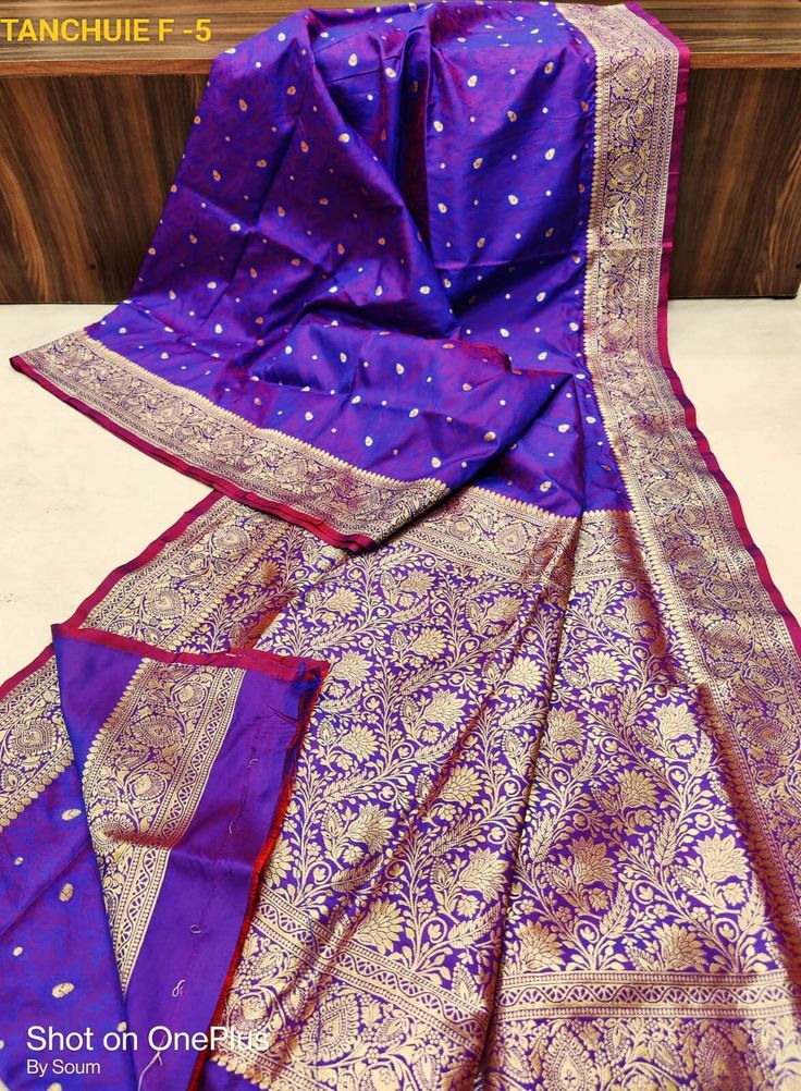 Very gorgeous rich looking weeding Benarasi silk Saree. Deep blueish purple dual tone shade saree with Alloverbody self weaving floral motifs and minakari zari weaving.Rich Benarasi zari woven pallu and Border.Alloverbody has rich floral Minakari zari woven design. Soft light weight saree,body hugging ,easy to carry. Best for weeding, Bridal ware,party ,or gift.  Blouse piece available. More color option is there. Please check availability before placing order. Purple Banarasi Silk Saree With Self Design, Traditional Purple Jamawar Wear, Semi-stitched Purple Banarasi Silk Saree, Purple Jamawar Traditional Wear For Diwali, Purple Jamawar Traditional Drape Wear, Purple Dola Silk Dupatta With Zari Weaving, Blue Handloom Dola Silk Dupatta, Purple Handloom Dola Silk Traditional Wear, Purple Zari Weaving Dola Silk Dupatta