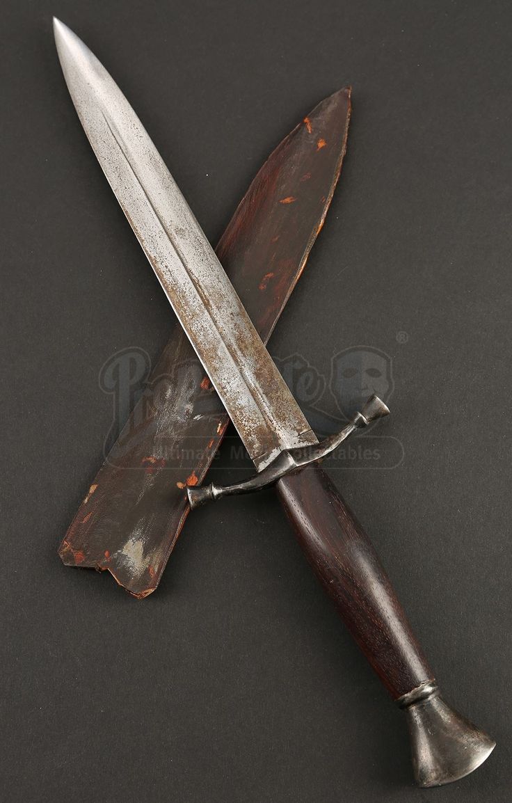 a knife that is sitting on top of a wooden handle with a blade attached to it