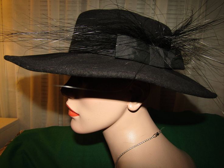 "Mr John black wool fedora style hat with 3 1/2\" wide banded brim, with flurry 5 to 6\" black feathered/ribbon bow band on one side. Possible 1950's era, with circumference of inside crown is 21\". Band is circled with wire band, so it can be shaped for your style. Hat is in very good condition. I believe the feathers are Ostrich. PRICE IS $99.00SALE FINAL/AS IS/NO RETURNS." Black Formal Boater Hat With Flat Brim, Formal Black Boater Hat With Flat Brim, Classic Black Boater Hat For Party, Flat Brim Top Hat For Winter Party, Formal Black Wide Brim Costume Hat, Winter Party Top Hat With Flat Brim, Black Brimmed Formal Hat, Black Top Hat With Wide Brim For Evening, Black High Crown Top Hat For Spring