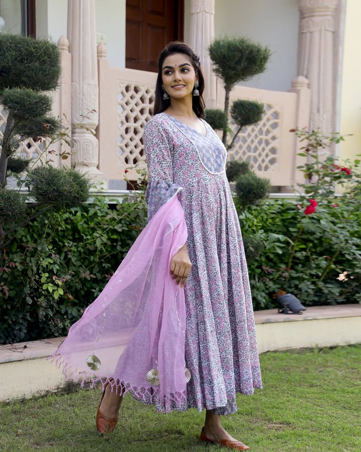 This is a 3-piece set. It comes with soft cotton hand block print anarkali kurta with 32 kali, round neck, 3/4th bell sleeves ankle length.The set also comes with handblock print pants with semi elasticated waistband and kota doria dupatta with gota detailing. Color-Pink & Purple Kurta Fabric-Soft Cotton Bottom Fabric-Cotton Dupatta Fabric-Kota Doria Work-Block Print Neck-Round Neck Sleeves-3/4th Bell Sleeves Washing Care-Dry Clean Only Bohemian Long Sleeve Anarkali Set With Cutdana, Spring Long Sleeve Cutdana Anarkali Set, Bohemian Cotton Anarkali Set With Dupatta, Bohemian Cotton Anarkali Set With Block Print, Bohemian Cotton Anarkali Set With Printed Motifs, Bohemian Mulmul Anarkali Set With Floral Print, Spring Mulmul Anarkali Set, Multicolor Long Sleeve Anarkali Set With Kalamkari Print, Cotton Fitted Anarkali Set With Block Print