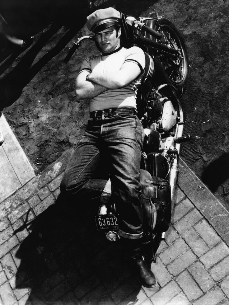 a man sitting on top of a motorcycle