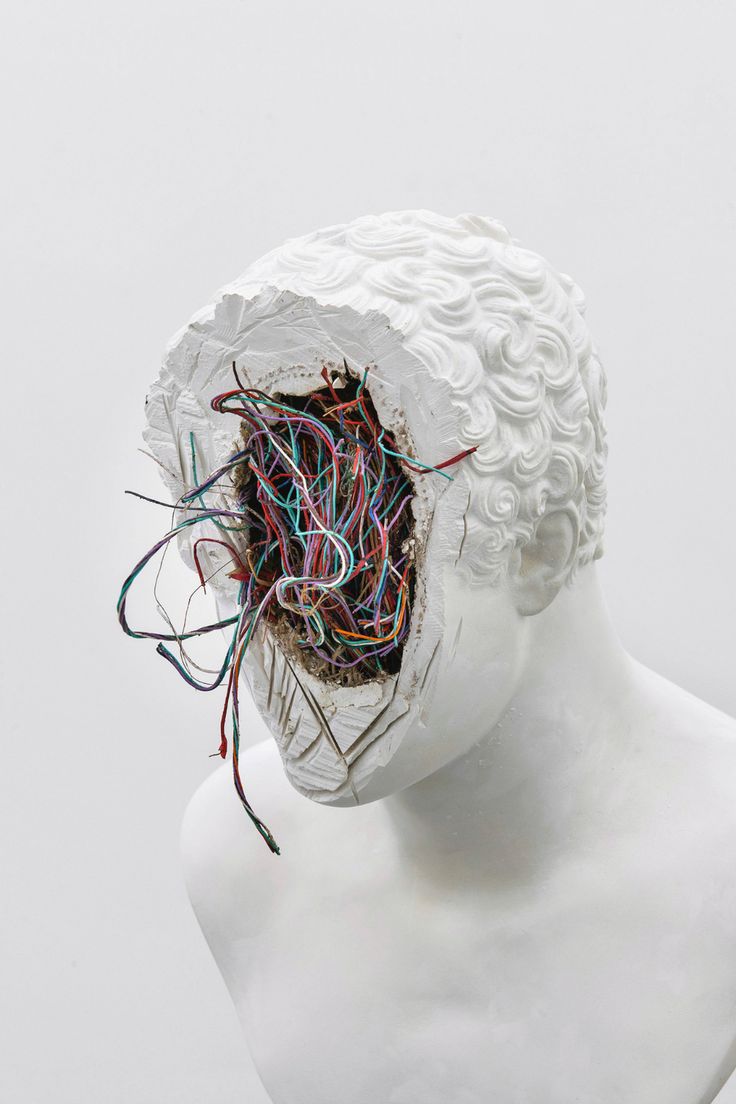 a white mannequin head with wires attached to it's face and hair