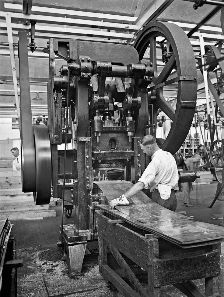 a man working on machinery in a factory