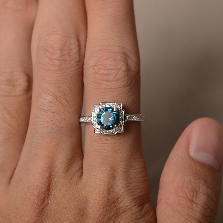 This is a gorgeous handmade creation. Its beauty is its simplicity & Elegance. The 7*7mm round cut London blue topaz is crafted in solid sterling silver and with rhodium plated. All item is sent in a beautiful gift box You can realize more lovely stuff clicking the link https://www.etsy.com/shop/knightjewelry?refshopsection_shophome_leftnav Please leave the correct address and you phone number for delivering successfully. Gift Round Cut Topaz Birthstone Ring, Gift Topaz Birthstone Ring With Round Cut, Sapphire-colored Topaz Ring With Round Cut, Sapphire Topaz Promise Ring, Sapphire Topaz Round Ring For Promise, Round Cut Blue Topaz Birthstone Diamond Ring, Sapphire Topaz Ring For Promise, Blue Topaz Birthstone Diamond Ring With Round Cut, Halo Ring With Birthstone Diamond In Round Cut