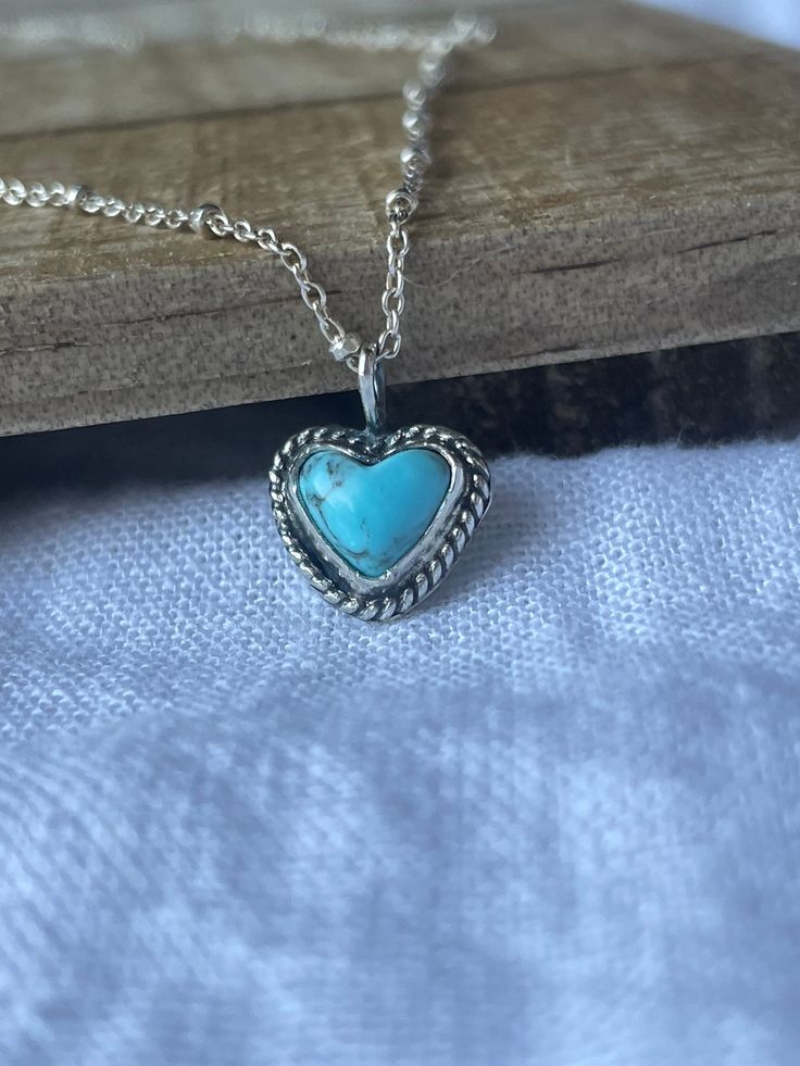 -Made with sterling silver -Made with Real Turquoise -16in chain -Handmade with love * Because of the handmade nature of the ring, there may be slight imperfections that will not affect the quality of the ring* Handmade Sterling Silver Heart Necklace With Round Pendant, Bohemian Sterling Silver Heart Necklace, Unique Sterling Silver Necklace With Heart Charm, Adjustable Turquoise Heart Pendant Jewelry, Blue Turquoise Necklace Stamped 925 As A Gift, Dainty Turquoise Pendant Necklace Gift, Dainty Turquoise Pendant Necklace For Gift, Artisan Sterling Silver Heart Necklace, Gift Blue Turquoise Necklace Stamped 925