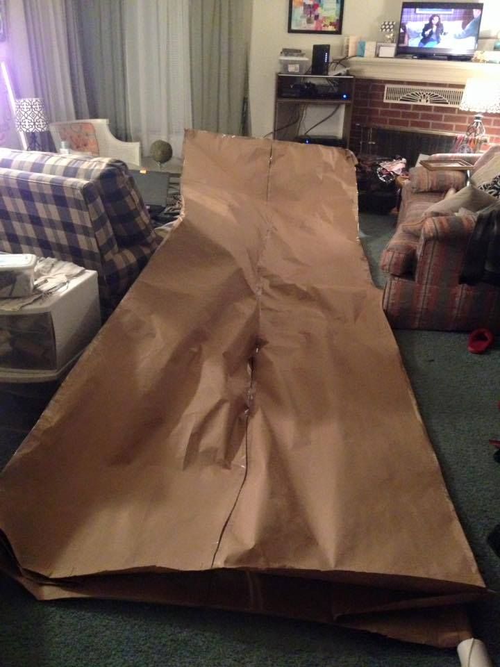 a brown paper bag laying on the floor in front of a tv and couches