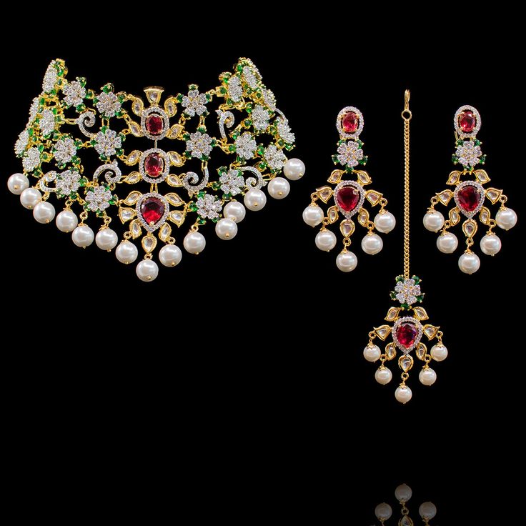 This set is not only beautiful for any wedding occasion but is a timeless piece of art! Stunning and classy set adorned with kundan stones and glistering ruby, emerald and CZ stones. Approximate earrings length is 3". This set is available in 2 options: Necklace + Earrings Necklace + Earrings + Teekah Please select the desired option at the time of purchase. Gold-plated on high-quality brass as base metal. Naleen Set (Without Teekah) is in-stock & ready-to-ship. Delivery time frame for the Nalee Ruby Emerald, Piece Of Art, Cz Stone, Necklace Earrings, Base Metal, Earring Necklace, Timeless Pieces, Statement Necklace, Ruby