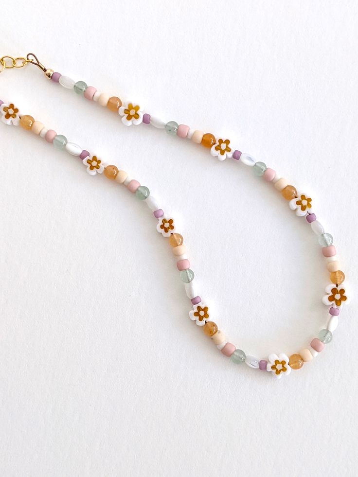 The perfect spring necklace 🌼 Choker style Gold-filled chain, clasp, & extender Intended for ages 2 years & up. Adjustable Whimsical Beaded Necklaces, Spring Beach Beaded Necklaces With Round Beads, Trendy Flower-shaped Beaded Necklaces For Summer, Trendy Summer Beaded Necklaces With Flower Shape, Trendy Summer Flower Shaped Beaded Necklaces, Adjustable Playful Beaded Necklaces With Tiny Beads, Handmade White Beaded Necklaces For Spring, Colorful Beaded Necklaces For Spring, Colorful Round Beaded Necklaces For Spring