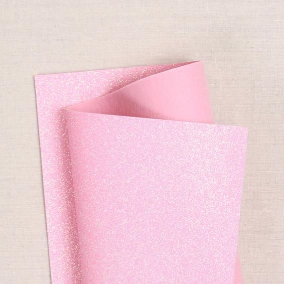 pink glitter paper folded on top of each other