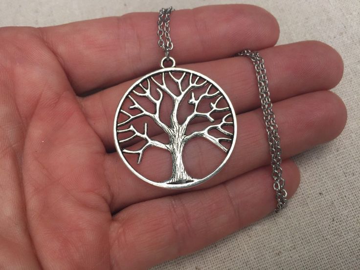 "Here is a simple and chic silver tree pendant necklace. It is timeless and versatile. Perfect for everyday, year round wear. This would make a very thoughtful gift as well. The round tree measures 1 3/8\" long by 1 1/4\" wide and hangs from a simple 18\" stainless steel necklace chain. I have matching earrings in my shop, if you would like the whole set. Here is the link https://etsy.me/2nHHl1x Thanks for stopping by! Please take a moment and visit the rest of my Etsy shop. I have many more uni Necklace Tree, Tree Jewelry, Tree Of Life Jewelry, Tree Necklace, Silver Tree, Tree Of Life Necklace, Big Tree, Jewelry Tree, Tree Pendant