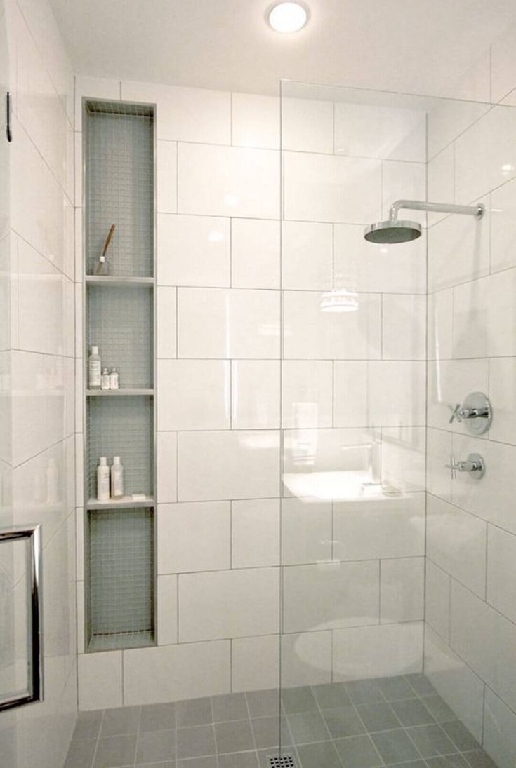 a bathroom with a shower, toilet and shelf