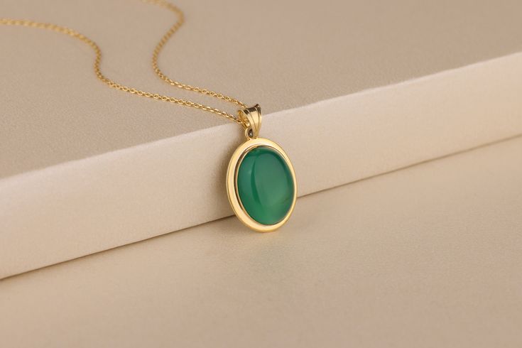 This gorgeous green agate gemstone necklace is made from genuine gemstone. The gemstones are selected by me and cut in such a way to make it uniquely shaped as well as beautiful on your neck. It is a timeless piece of jewelry that you can wear for any occasion or for everyday use. It is also a great gift idea for yourself or loved ones: mother's day, anniversary or just because... Details of the product Material: 10K and 14K Solid Gold, Silver Gemstone: Green Agate Gemstone Gemstone Size: 12x16 mm Unique Gift For people whom you love; Mom, Girlfriend, Wife, Fiance, Best Friend; Dainty Gift Idea; Valentine's Day Gift, Birthday Gift, Anniversary Gift, Gift For Engagement or Wedding, Promise Gift, Christmas Gift, Black Friday Gift, Mother's Day Gift, International Women's Day Gift, Memorial G Elegant Jade Cabochon Necklace, Oval Jade Cabochon Necklace, Oval Jade Cabochon Necklaces, Elegant Green Agate Jewelry, Green Cabochon Oval Pendant Necklace, Elegant Round Chrysoprase Necklaces, Elegant Oval Emerald Necklace With Natural Stones, Elegant Cabochon Necklace For May Birthstone, Chrysoprase Oval Pendant Necklace As Gift