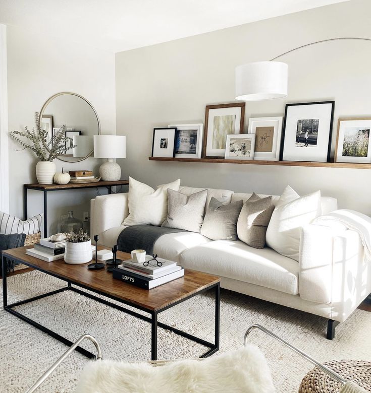 a living room filled with furniture and pictures on the wall