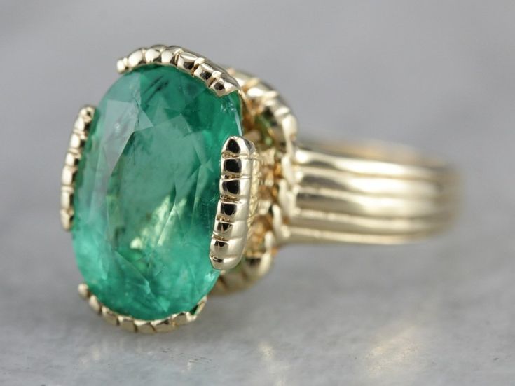 This vintage emerald ring is a simple, and quite a versatile piece with clean lines and great proportions. This ring is classic and traditional, featuring a solid gold head to hold the stone securely. The beautiful emerald has a shade of green that is just the same as the brightest springtime leaves. Metal: 14K Yellow Gold Gem: Emerald 4.08 Carats Gem Measurements: 12.1 x 8.5 mm, Oval Ring Size: 6 Marks: "KIMBERLY 14K" Stamped on the inside band Elegant 14k Stamped Emerald Ring, Timeless Bezel-set Emerald Ring For May Birthstone, Timeless Emerald Ring With Bezel Setting For May Birthstone, Timeless Bezel Set Emerald Ring For May Birthstone, Timeless May Birthstone Emerald Ring With Bezel Setting, Timeless Yellow Gold Emerald Ring, Timeless Green Emerald Ring With Bezel Setting, Heirloom Oval Emerald Ring, Timeless Polished Emerald Ring