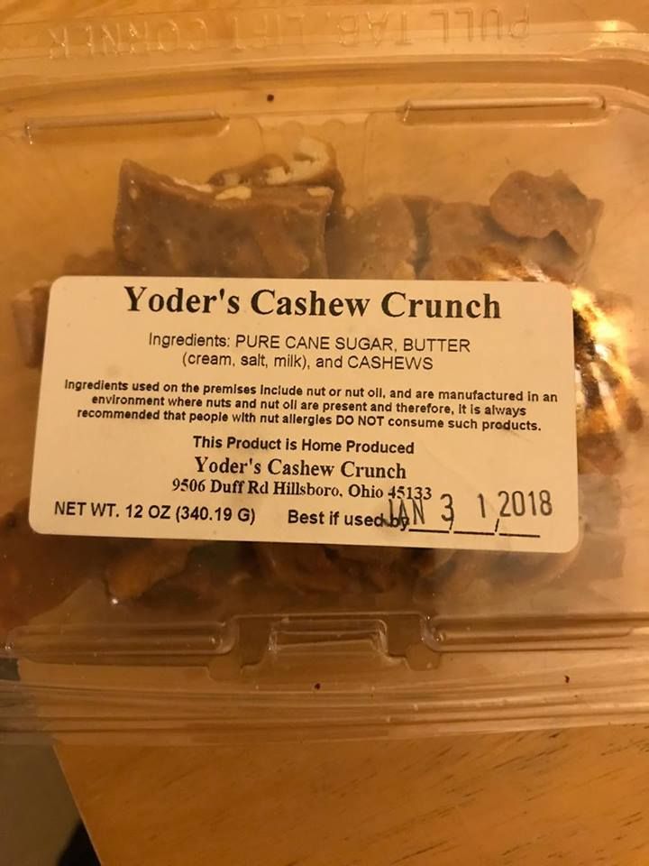 yoder's cashew crunch in a plastic container with label on the side