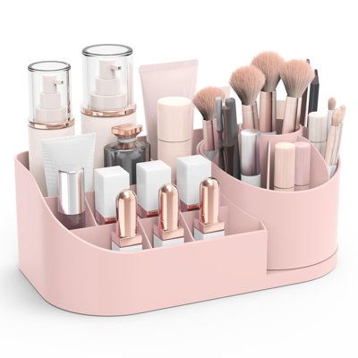 This product countertop makeup organizer provides ample space to store your makeup, brushes, and skincare products, keeping them neatly organized and easily accessible. The built-in makeup brush holder on this cosmetic display case helps to keep the brushes organized, making it convenient for your daily makeup routine. Everly Quinn | Everly Quinn Lisabelle Plastic Makeup Organizer pink / redPlastic | 4.93" H X 9.65" W X 5.71" D | Wayfair | Organization Vanity With Makeup, Ocean Room Ideas, Countertop Makeup Organization, Rotating Makeup Organizer, Rectangular Prism, Ocean Room, Daily Makeup Routine, Display Showcase, Countertop Organization