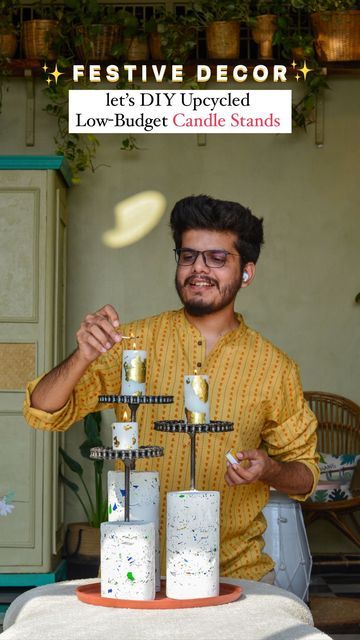 a man standing in front of a cake with candles on it