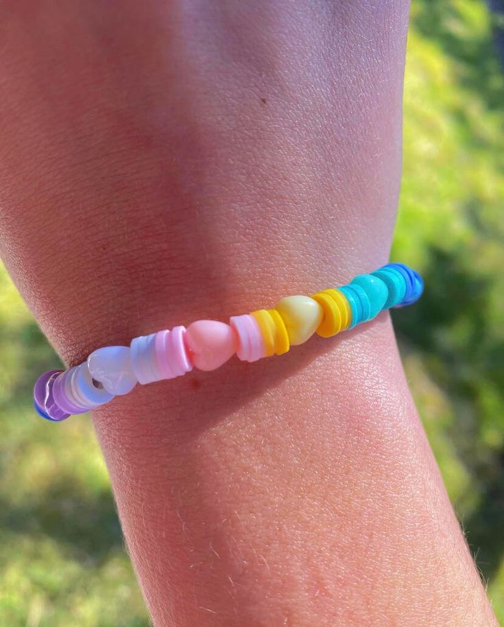 When you wear this fun and cheery candy heart bracelet, you will feel love even in the darkest of times. This bracelet has the fun colors of light pink, yellow, teal, dark blue, purple, and white. 𝕭𝖗𝖆𝖈𝖊𝖑𝖊𝖙 𝖈𝖆𝖗𝖊: for the best care for your bracelet please do/don't: -DO wear your unique bracelet with pride (it's one of a kind, show it off -DO expect to get compliments (people are going to like it) -DO tell people that it's from BooBearsBraceletCo after they compliment you - DONT put in Trendy Multicolor Heart Bracelet With Colorful Beads, Trendy Multicolor Heart Charm Bracelet, Trendy Multicolor Beaded Heart Bracelet, Multicolor Heart Charm Bracelet For Friendship, Multicolor Heart Beads Bracelet For Friendship, Trendy Multicolor Heart Bracelet For Friendship, Cute Multicolor Heart Bracelet For Friendship, Cute Multicolor Friendship Bracelets With Heart Beads, Everyday Multicolor Heart-shaped Beaded Bracelets