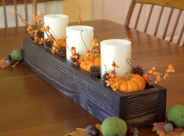 some candles are sitting on a wooden table