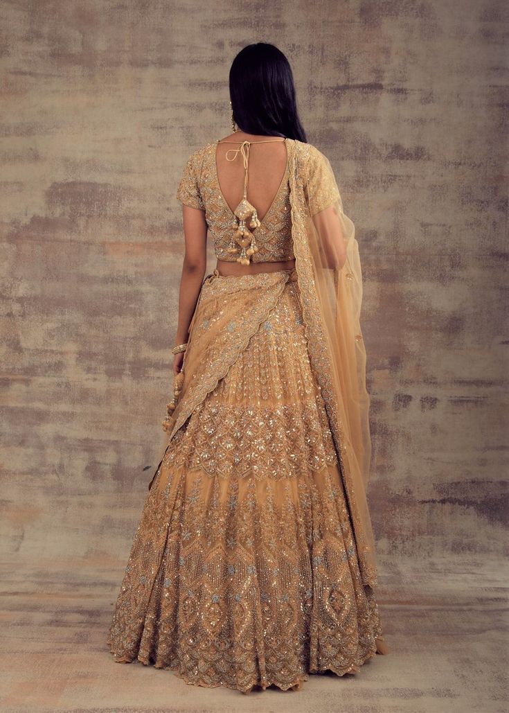 Minimalist Yet Elegant Gold Lehenga For Our Beautiful Ladies! All the women - whether they are from India or any other country have always embraced the unparalleled charm of Lehengas. Lehenga has become the preferable attire for a wedding or special occasion owing to the kind of comfort and elegance this attire provides. Keeping in mind your taste and class, Ruhani Collection have come up with this beautiful gold-coloured lehenga. Beautified with silver and gold embroidery, this lehenga is enoug Traditional Drape Sets With Cutdana For Wedding, Traditional Drape Wedding Sets With Cutdana, Wedding Sets With Cutdana In Traditional Drape, Elegant Ceremonial Lehenga With Traditional Drape, Elegant Lehenga With Dupatta For Ceremony, Elegant Traditional Drape Lehenga For Ceremony, Elegant Anarkali Set For Wedding With Traditional Drape, Elegant Choli For Ceremony With Traditional Drape, Elegant Ceremony Choli With Traditional Drape