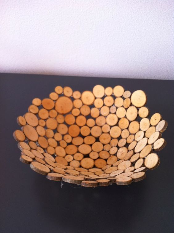 a wooden bowl sitting on top of a black table