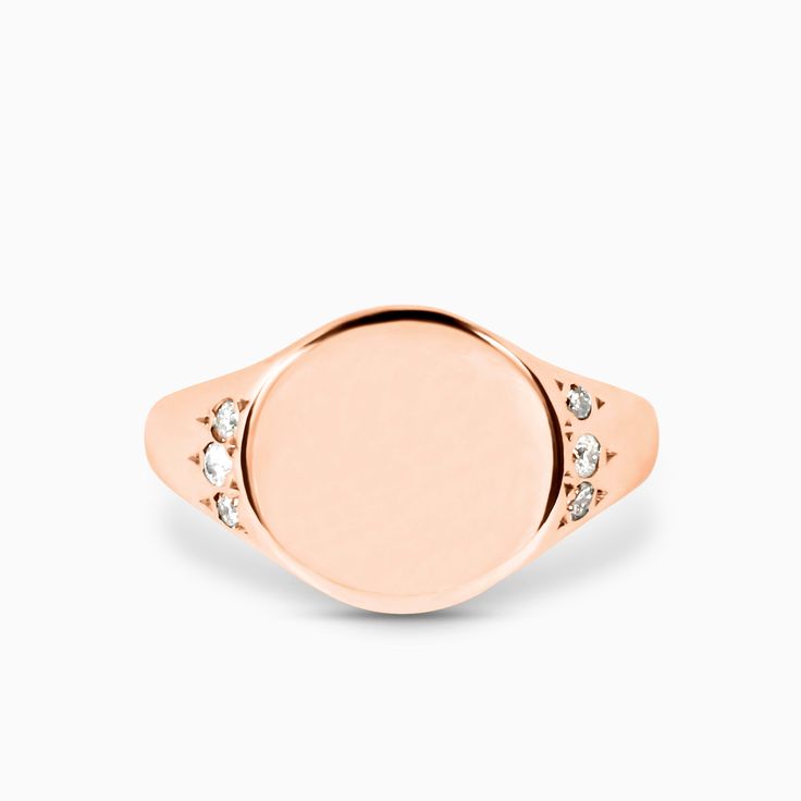 This petite classic Signet Ring makes a statement. The ring surface is a 10x10mm circle, domed on either side with small diamond accents. The signet ring has been used throughout history and across cultures to showcase family crests and position in society. For an added touch, include details for a complimentary monogram or symbol in your notes upon check out. All monograms and symbols are hand-engraved by Brooklyn Engravings. Before your signet ring is hand engraved an email will be sent to you Formal Signet Ring With Polished Round Stone, Formal Signet Ring With Polished Finish, Rose Gold Diamond Signet Ring In Fine Jewelry Style, Rose Gold Polished Finish Signet Ring, Rose Gold Polished Finish Round Cut Signet Ring, Luxury Rose Gold Signet Ring With Brilliant Cut, Timeless Diamond Signet Ring, Classic Oval Diamond Signet Ring, Rose Gold Signet Ring For Promise Fine Jewelry