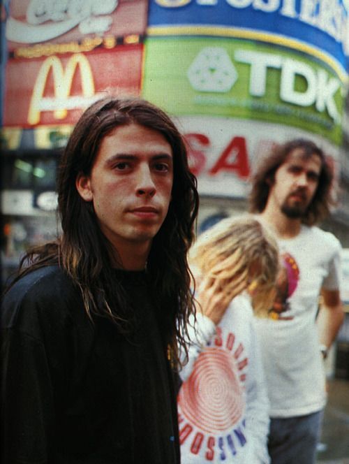 two young men standing in front of a mcdonald's