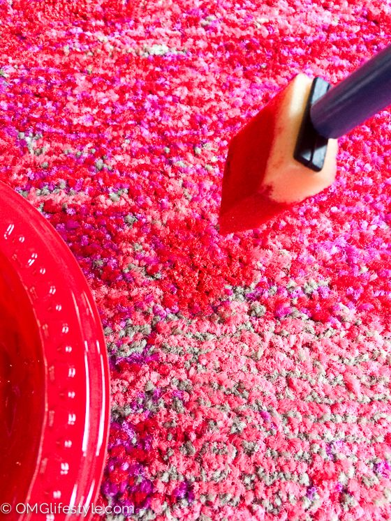 a close up of a pink carpet with a brush