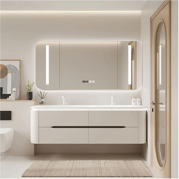 a white bathroom with two sinks and mirrors