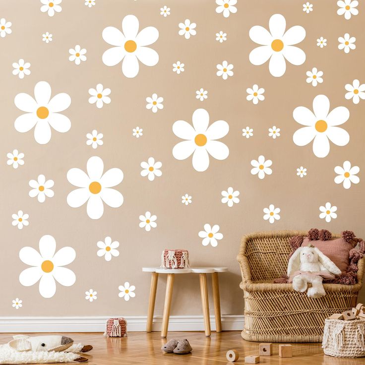 a living room with white flowers on the wall and wooden flooring in front of it