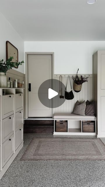 a living room filled with furniture and lots of storage space next to a wall mounted cabinet