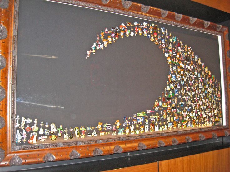 there is a framed picture with many small figurines in the shape of a wave