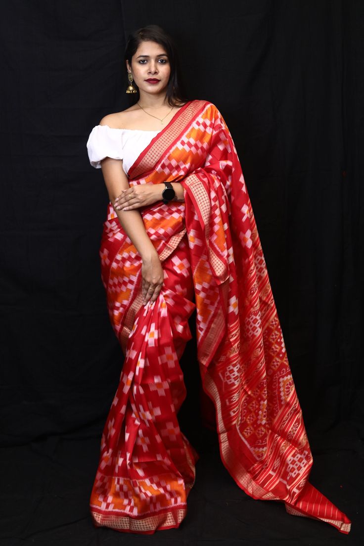 Weaver communities of Maniabandha and Nuapatana of Odisha traditionally weave this kind of saree. Common motifs are star, temple, conch, rudraksh, fish, chakra, lotus etc. The inspiration of all its designs comes from nature. It is the best of single ikat; one of warp and weft is tied and dyed prior to weaving. The borders and the pallas have tremendous variety and each one of them is attractive and praiseworthy. Specification:  Occasion: Festive Wear Fabric: Mulberry Silk, silk Primary Color:Red Secondary Color: Maroon Material : Mulberry Silk Pattern: Motif Border Type: Ikkat Border Size: Medium Blouse Piece: Included Care: Dry Clean Disclaimer : This is a genuine handwoven piece, & that could expect unevenness in the selvedge and weave, and colours may fade or bleed due to the tradition Red Pre-draped Saree With Traditional Patterns For Navratri, Multicolor Ikat Print Pre-draped Saree For Navratri, Red Tussar Silk Pre-draped Saree With Motifs, Traditional Ikat Print Pre-draped Saree For Festivals, Navratri Ikat Print Pre-draped Saree, Bollywood Ikat Print Blouse Piece For Festivals, Traditional Drape Blouse Piece With Ikat Print For Festivals, Bollywood Style Festive Ikat Print Traditional Wear, Festive Bollywood Traditional Wear With Ikat Print