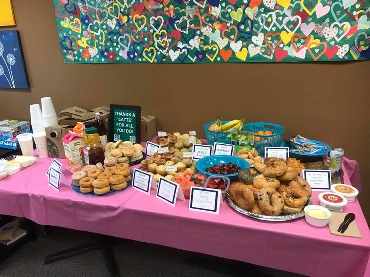 a pink table topped with lots of food