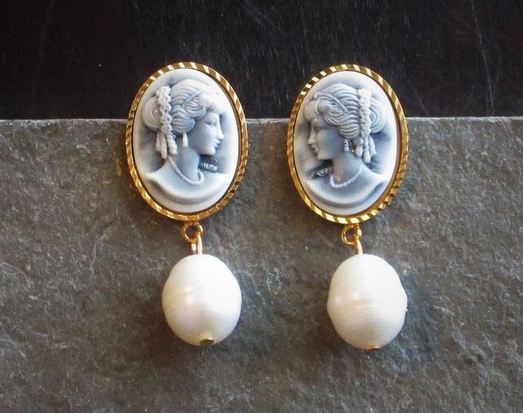 Beautiful vintage cameos in hazy black and cream set in plated gold, paired with real freshwater pearls. Earrings have stud backs. Details: Earrings measure 1.5 inches in length Settings are plated brass Lightweight Pearls are real freshwater pearls Lead and nickel free For sanitary reasons these earrings CANNOT be returned Thank you for shopping Delicate Industry :) Elegant Cameo Earrings, Cameo Drop Earrings For Wedding, Elegant Cameo Earrings As Gift, Elegant Cameo Earrings For Gift, Elegant Cabochon Pearl Drop Earrings, Elegant Evening Jewelry With Cameo Detail, Elegant Cameo Drop Earrings, Elegant Cameo Clip-on Earrings Gift, Classic Cameo Earrings For Wedding